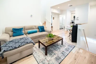 a living room with a couch and a table at New York loft- style 3 levels 2 Bath by Hollywood in Los Angeles