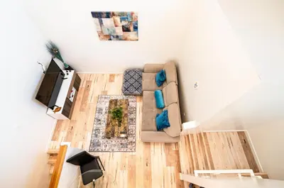 a living room with a couch and a tv at New York loft- style 3 levels 2 Bath by Hollywood in Los Angeles