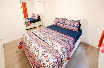 a small bedroom with a bed and a mirror at Cozy Koreatown/Hollywood 2 Bedroom in Los Angeles