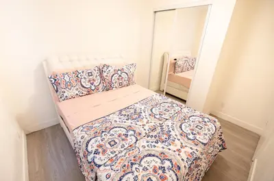 a small bedroom with a bed with a quilt at Cozy Koreatown/Hollywood 2 Bedroom in Los Angeles