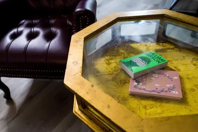 a glass table with two books on top of it at Artful Retreat - King Bed, Work Desk, WIFI, Unique Murals, Perfect for Business Travelers, Downtown & Near Universal Studios in Burbank