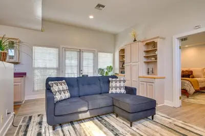 a living room with a blue couch and a bedroom at Luxe Pasadena Casita with Fireplace and Grill in Pasadena