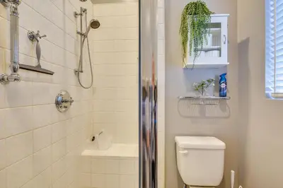 a bathroom with a shower and a toilet and a sink at Luxe Pasadena Casita with Fireplace and Grill in Pasadena