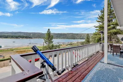 a view of the water from the balcony of a house at North Shore Chalet by Big Bear Vacations Lakeside Fawnskin Estate Boat Dock Lake Access in Fawnskin