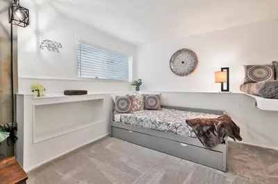 a bedroom with a bed and a window at North Shore Chalet by Big Bear Vacations Lakeside Fawnskin Estate Boat Dock Lake Access in Fawnskin