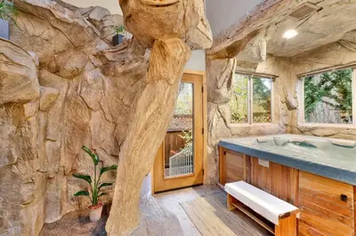 a large bathroom with a large rock wall at The Spa at Winterset- Incredible Resort Estate Chalet- Indoor Hot Tub- Games in Big Bear Lake
