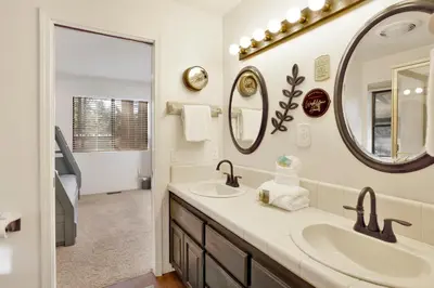 a bathroom with two sinks and a mirror at Soaring Pines by Big Bear Vacations Central Cozy Estate Chalet in Big Bear Lake