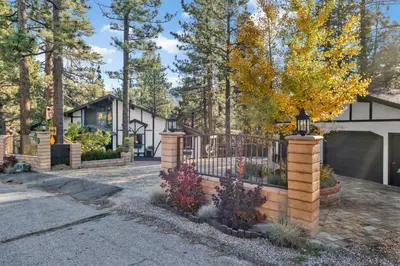 a fence in front of a house at Soaring Pines by Big Bear Vacations Central Cozy Estate Chalet in Big Bear Lake