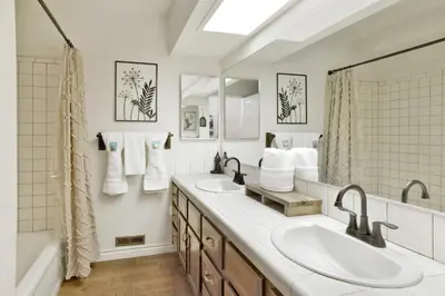 a bathroom with two sinks and a large mirror at Soaring Pines by Big Bear Vacations Central Cozy Estate Chalet in Big Bear Lake