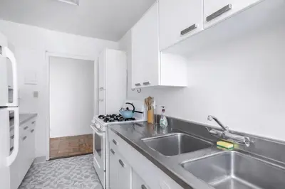 a white kitchen with a sink and a stove at Spacious 2 Bedroom 2 Bathroom Unit Great Location in Los Angeles