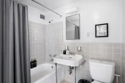 a white bathroom with a sink and a toilet at Spacious 2 Bedroom 2 Bathroom Unit Great Location in Los Angeles