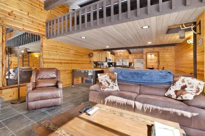 a living room with a couch and a table at Smith Chalet at Snow Summit- Furnished Resort Condo- Foosball- Walk To Lifts in Big Bear Lake