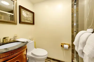 a bathroom with a toilet and a sink and a shower at Smith Chalet at Snow Summit- Furnished Resort Condo- Foosball- Walk To Lifts in Big Bear Lake