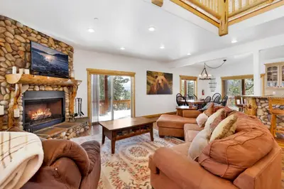 a living room with couches and a fireplace at Cozy Lakeview Hideaway by Big Bear Vacations Amazing Fawnskin Log Cabin Chalet in Fawnskin