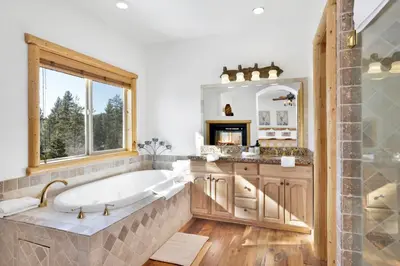 a large bathroom with a tub and a window at Cozy Lakeview Hideaway by Big Bear Vacations Amazing Fawnskin Log Cabin Chalet in Fawnskin