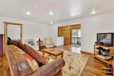 a living room with a couch and a tv at Cozy Lakeview Hideaway by Big Bear Vacations Amazing Fawnskin Log Cabin Chalet in Fawnskin