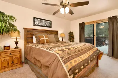 a bedroom with a bed and a ceiling fan at Swiss Delight by Big Bear Vacations Hot Tub Game Tables Central in Big Bear Lake