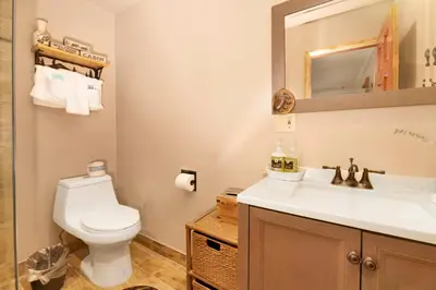 a bathroom with a white toilet and a sink at Swiss Delight by Big Bear Vacations Hot Tub Game Tables Central in Big Bear Lake