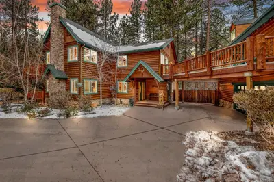 a log house with a large driveway in front of it at Fawnskin Log Cabin- Luxurious Group Log Cabin Estate- Hot Tub- Walk to Lake in Fawnskin