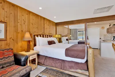 a bedroom with a large bed and a couch at Forest Shores Lake View Condo by Big Bear Vacations Lakefront Village in Big Bear Lake