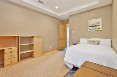 a bedroom with a white bed and a closet at Sunset Ridge Villa- Incredible Log Cabin Estate- Hot Tub- Game Tables- in Big Bear Lake