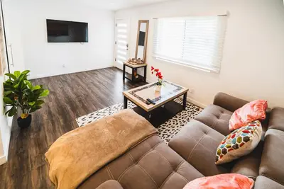 a living room with two couches and a table at Nice and Close to Downtown 1 Bedroom Sleeps 4 in Los Angeles