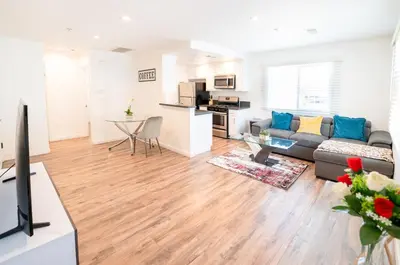 a living room with a couch and a table at Modern Furnished 1-Bedroom with Free Parking in Koreatown close to DT LA in Los Angeles
