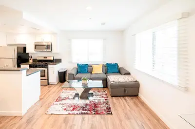 a living room with a couch and a table at Modern Furnished 1-Bedroom with Free Parking in Koreatown close to DT LA in Los Angeles
