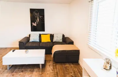 a living room with a couch and a table at Cozy Koreatown 1 Bedroom Modern Furnished Free Parking in Los Angeles