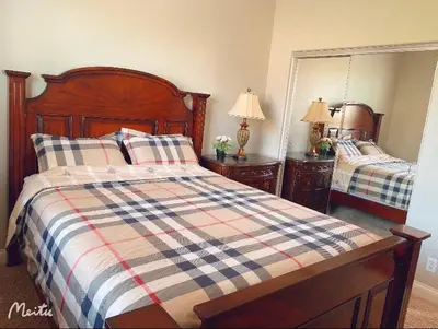 a bedroom with a bed with a plaid blanket at Cozy And Comfortable #202 Room in Corona