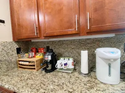 a kitchen counter with a coffee maker on a counter top at Cozy And Comfortable #202 Room in Corona