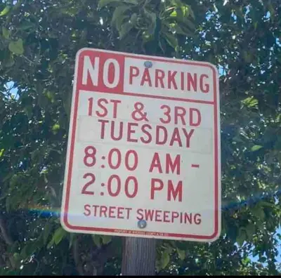 a no parking sign in front of a tree at Cozy And Comfortable #202 Room in Corona