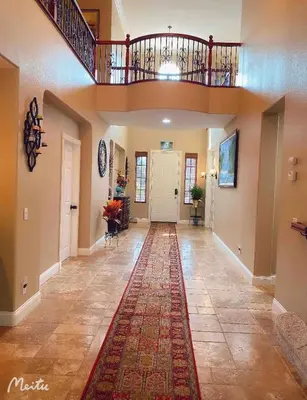 a hallway with a rug on the floor and a staircase at Cozy And Comfortable #202 Room in Corona