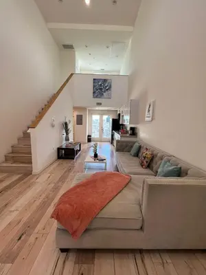 a living room with a couch and a staircase at Modern One-Bed Loft in Hollywood Sign View & Free Parking in Los Angeles