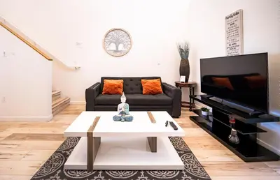 a living room with a couch and a coffee table at Chic 1-Bed Hollywood Loft Iconic Sign Views & Private Parking in Los Angeles