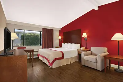 a hotel room with a bed and a television at Ramada by Wyndham Torrance in Torrance