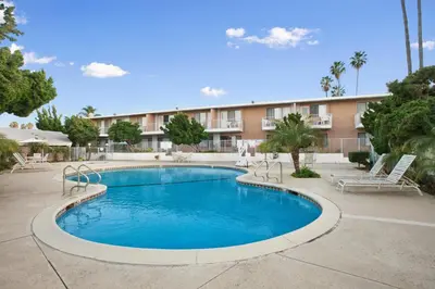 a swimming pool in front of a building at Ramada by Wyndham Torrance in Torrance
