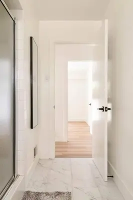 a white hallway with a door leading to a room at 30 PCT OFF! Malibu Villa, Ocean View, Beach, Hiking in Malibu