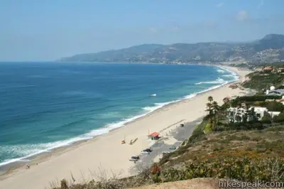 a beach with chairs and umbrellas and the ocean at Malibu Ocean Villa with King Bed, Hot Tub, Beach, BBQ in Malibu