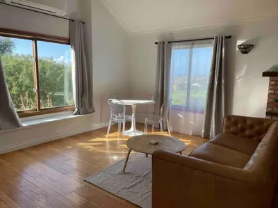 a living room with a couch and a table and windows at 30 PCT OFF! Malibu Romantic Suite, Ocean View, Beach in Malibu