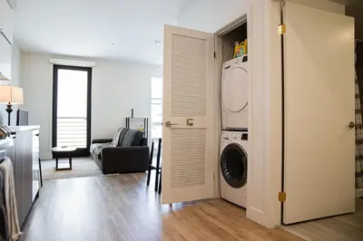 a living room with a washer and dryer at Luxury Apartment With The Hollywood Hills View in Los Angeles