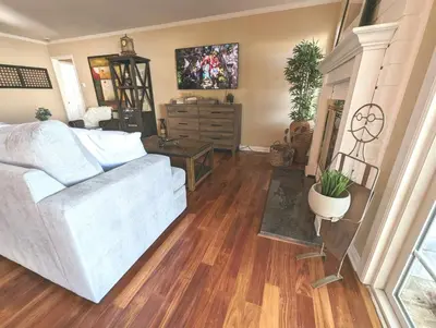 a living room with a white couch and wooden floors at 4 BR Encino Home w/ Amazing Yard, Near Everything in Encino
