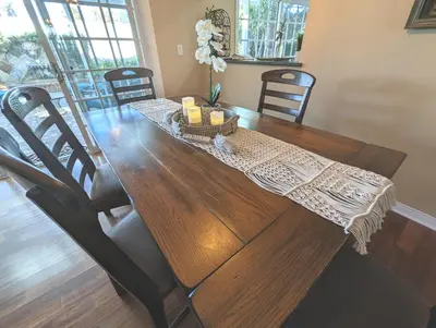 a wooden dining room table with two candles on it at 4 BR Encino Home w/ Amazing Yard, Near Everything in Encino