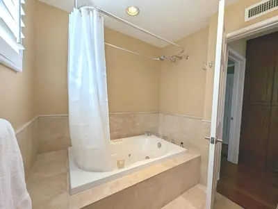 a bathroom with a bath tub with a shower at 4 BR Encino Home w/ Amazing Yard, Near Everything in Encino