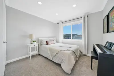 a white bedroom with a bed and a window at Private Heated Pool Oasis/Disney/Retro Arcade/Gym in Placentia