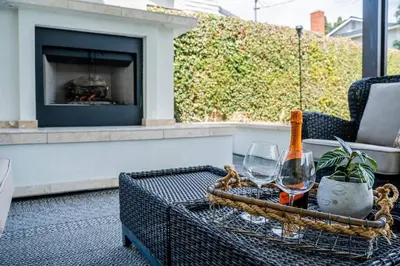 a table with two glasses and a bottle of wine at Private Heated Pool Oasis/Disney/Retro Arcade/Gym in Placentia