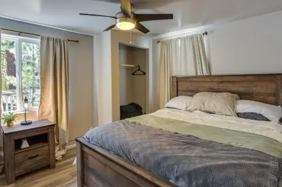 a bedroom with a bed and a ceiling fan at Less Than 1 Mi to Big Bear Lake Fawnskin Cottage with Grill in Fawnskin