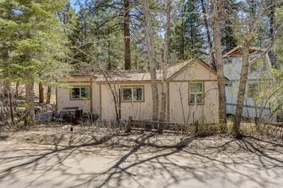a small house in the middle of the woods at Less Than 1 Mi to Big Bear Lake Fawnskin Cottage with Grill in Fawnskin