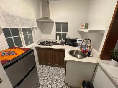 a small kitchen with a sink and a stove at Three Pines Cabins in Big Bear Lake