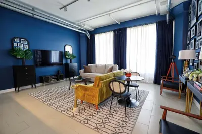 a living room with blue walls and a couch and a table at Downtown LA's Most Requested Property, Sleeps 4 with Free Parking! in Los Angeles
